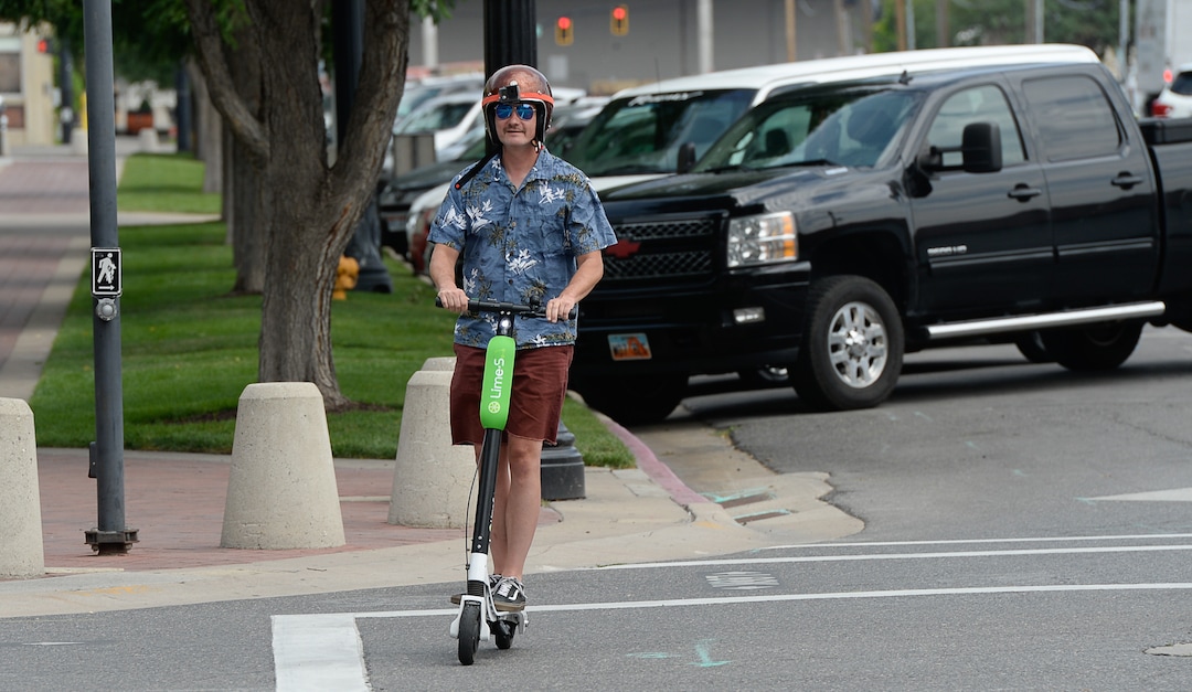 (Francisco Kjolseth  |  The Salt Lake Tribune)  Salt Lake Tribune columnist Robert Gehrke finishes his race against colleagues during a downtown transportation race from Library Square to the Tribune building at the Gateway on Thursday, Aug. 2, 2018. Modes of transportation included, rentable electric scooters, Green Bike, TRAX, Lyft, and walking.