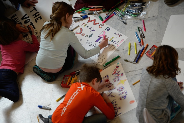 (Francisco Kjolseth  |  The Salt Lake Tribune)  Kids help to make signs in the Capitol rotunda on Monday, Jan, 28, 2019, on the first day of the Legislative session to rally in support of protecting Proposition 3, the Medicaid Expansion law recently passed by voters.