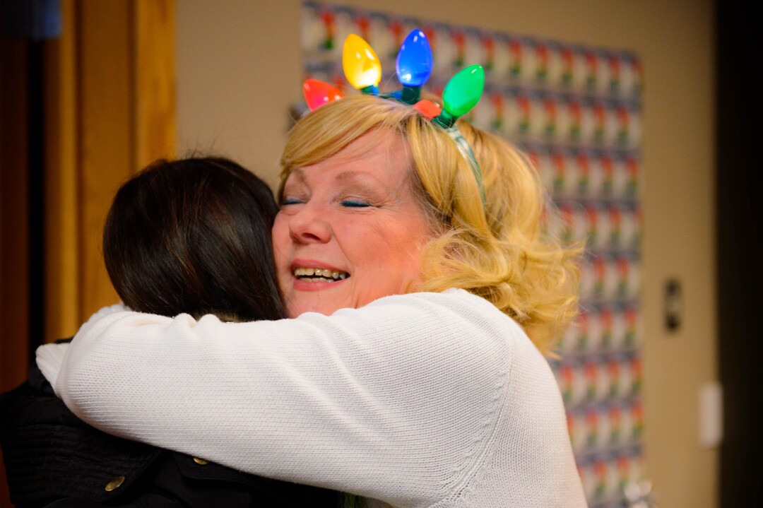 (Trent Nelson | The Salt Lake Tribune) Lynda Smart Brown, founder of KidsEat!, embraces a volunteer at a fundraiser and coat collecting event in Murray on Wednesday, Dec. 11, 2019.
