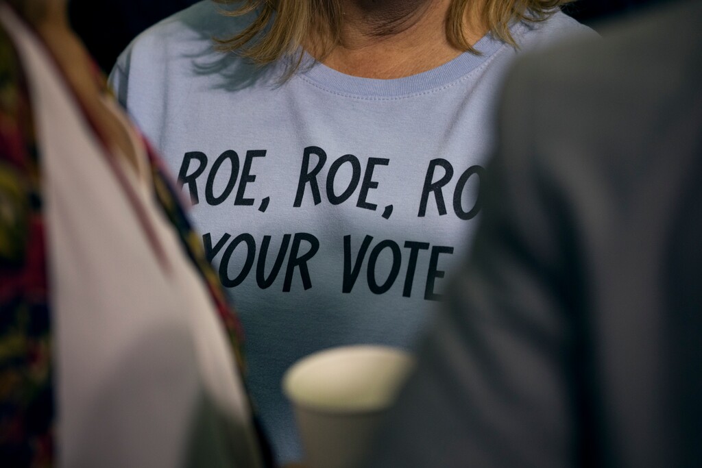 A supporter wearing a shirt referencing Roe v. Wade waits to see President Joe Biden speak at a campaign event focused on women’s reproductive rights at Hillsborough Community College in Tampa, Fla., April 23, 2024. (Damon Winter/The New York Times)