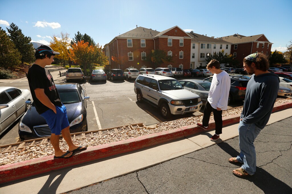 Students from the University of Utah look esday, Oct. 23, 2018, in Salt Lake City,  in the direction of a parking lot where Lauren McCluskey's body was found in a car. McCluskey, 21, a University of Utah student and track athlete, was shot and killed on campus by a former boyfriend she had filed a police complaint against after she learned he was a sex offender and broke off the relationship, authorities said Tuesday.  (AP Photo/Rick Bowmer)