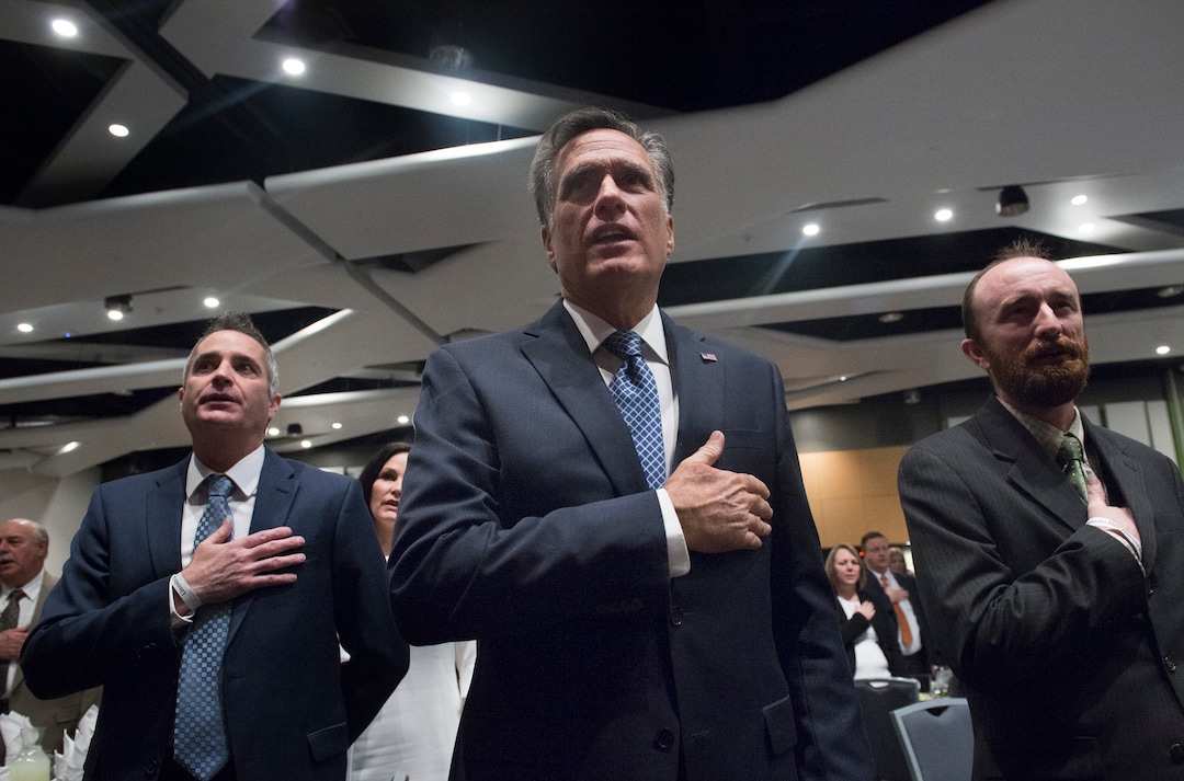 Scott Sommerdorf | The Salt Lake TribuneFormer Republican presidential candidate Mitt Romney stands for the pledge of allegiance Friday, February, 16, 2018. Romney is the keynote speaker at the 2018 Utah County Republican Party Lincoln Day Dinner.