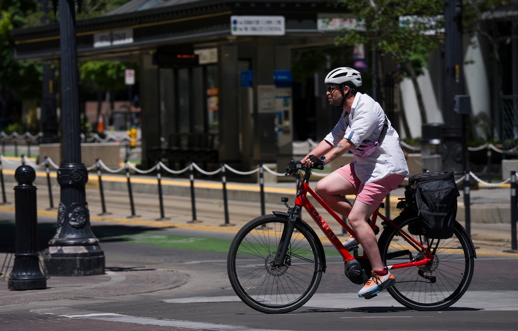 (Bethany Baker | The Salt Lake Tribune) A man rides a bike as temperatures climb in Salt Lake City on Thursday, July 9, 2026. Forecasters say Salt Lake City's high temperature reached 104 degrees Saturday, two degrees shy of the record — and there's a chance it will get even warmer on Sunday.