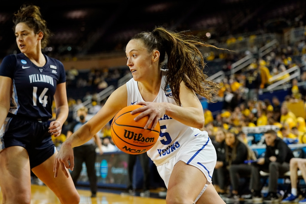 BYU guard Maria Albiero (5) drives as Villanova forward Brianna Herlihy (14) defends during the second half of a college basketball game in the first round of the NCAA tournament, Saturday, March 19, 2022, in Ann Arbor, Mich. (AP Photo/Carlos Osorio)