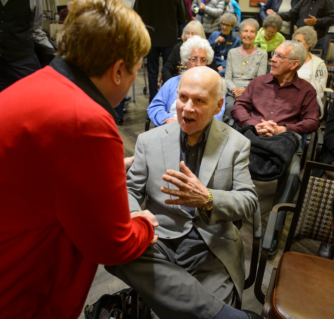 (Steve Griffin  |  The Salt Lake Tribune) Paul Christensen  visits with some of his former students following a Christmas concert at Cottonwood Place senior living community in Holladay Friday December 15, 2017. During the concert the Salt Lake Education Foundation presented a new scholarship in his honor. For 30 years, Christensen inspired generations of students at Highland High School to pursue their musical talents as the lively choral director of the schoolÕs many music programs.