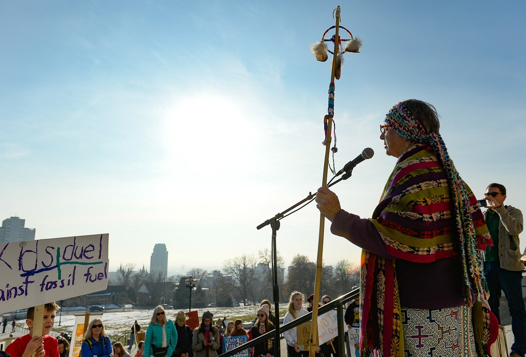 (Francisco Kjolseth  |  The Salt Lake Tribune)  Patricia Davidson sings a message to represent the elders and their support of youth striking for climate action as Fridays For Future, Utah Youth Environmental Solutions, and partners gather in opposition to UtahÕs final oil and gas lease sale of 2019 that will auction off public lands and further fossil fuel development during a rally on the steps of the Utah Capitol on Friday, Dec. 6, 2019.