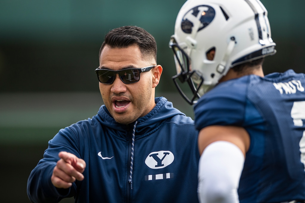 (Tyler Richardson | BYU) Running backs coach Harvey Unga, left, participates in BYU spring football practice, Thursday, March 18, 2021.