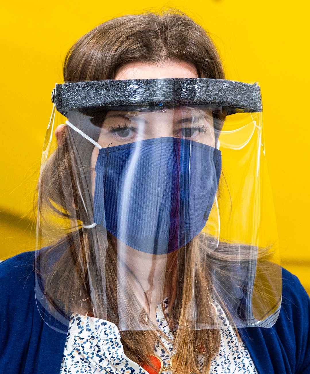 (Rick Egan  |  The Salt Lake Tribune)     Romy Humphries, director of marketing and sales at SugarHouse Industries, demonstrates the make face mask and face shields they are producing to protect against coronavirus, Thursday, March 26, 2020.