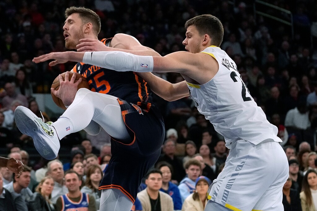 New York Knicks center Isaiah Hartenstein (55) and Utah Jazz center Walker Kessler (24) vie for a rebound during the second half of an NBA basketball game Saturday, Feb. 11, 2023, in New York. (AP Photo/Bryan Woolston)