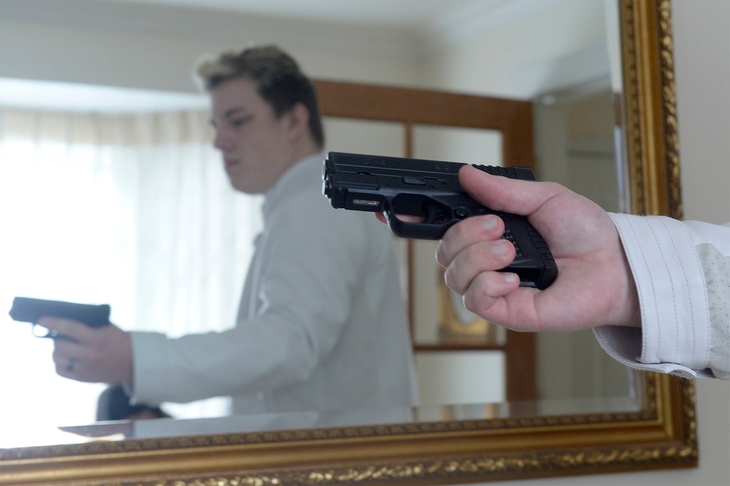 (Al Hartmann | Tribune file photo via AP) This March 1, 2018, file photo shows Jared Larson carrying a concealed firearm with a new provisional state permit, Centerville, Utah. On Friday, Feb. 12, 2021, gun-rights activists issued a celebratory news release saying Utah Gov. Spencer Cox had signed a bill to do away with the law requiring a permit to carry a concealed weapon.
