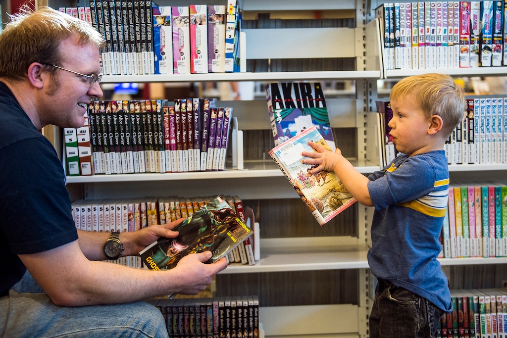 ( Chris Detrick | The Salt Lake Tribune) Peirce Frandsen, 2, helps his dad, Jordan Frandsen, pick out books during the grand opening of the Glendale Branch library in 2015. Research shows the amount of time that dads are spending with their kids has been steadily increasing over time.