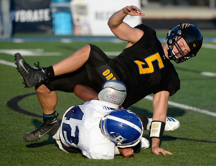 (Francisco Kjolseth  |  The Salt Lake Tribune)  Orem's quarterback Cooper Legas is taken down by Bingham's Sione Fotu in the first half of the game Thursday, Aug. 16, 2018 in Orem.