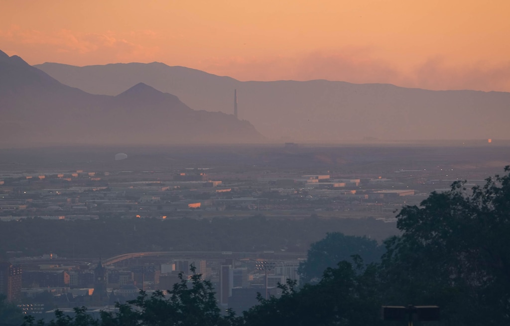 (Francisco Kjolseth | The Salt Lake Tribune) The Salt Lake Valley is obscured by smoke in the setting sun as crews battle a fire in the foothills above the University of Utah on Saturday, June 20, 2026.