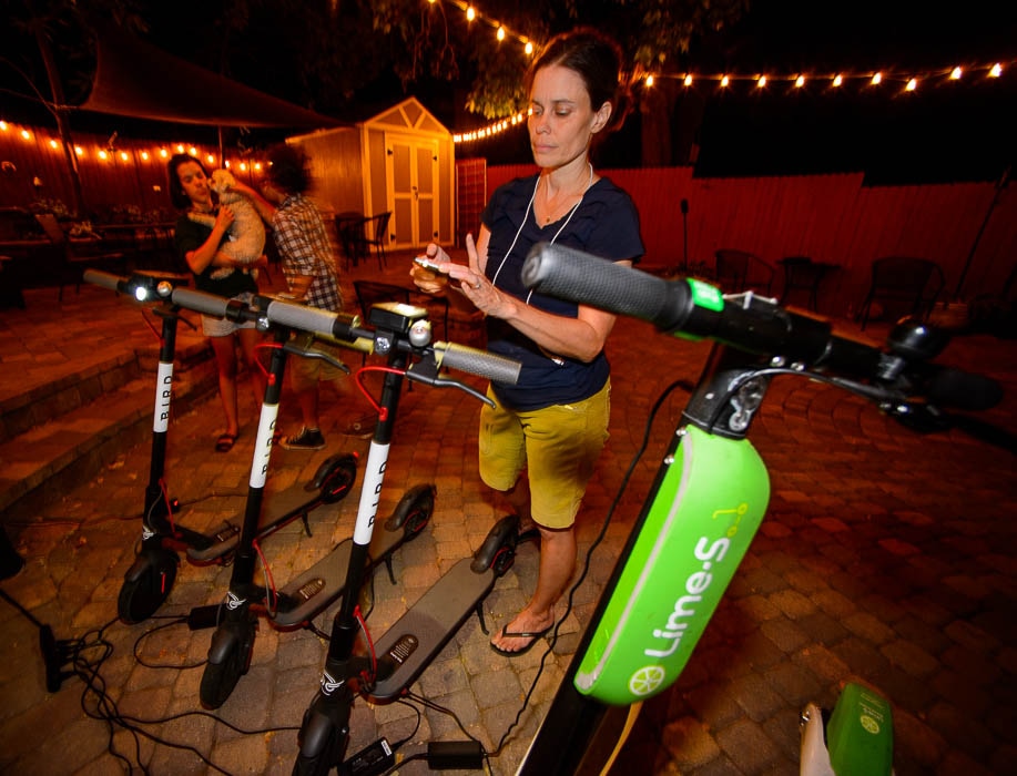 (Trent Nelson | The Salt Lake Tribune) Jenn Hein charges scooters in Salt Lake City Tuesday Aug. 7, 2018. Jenn Hein works as a "Bird charger" on the side to make some extra cash, picking up and charging electric scooters overnight and returning them to the city streets in the early morning.
