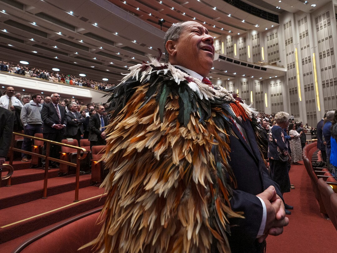 (Leah Hogsten | The Salt Lake Tribune) Dr. Ash Puriri of New Zealand, dressed in a sacred Maori cloak, sings with fellow members of The Church of Jesus Christ of Latter-day Saints during the morning session of General Conference on Saturday, April 1, 2023.