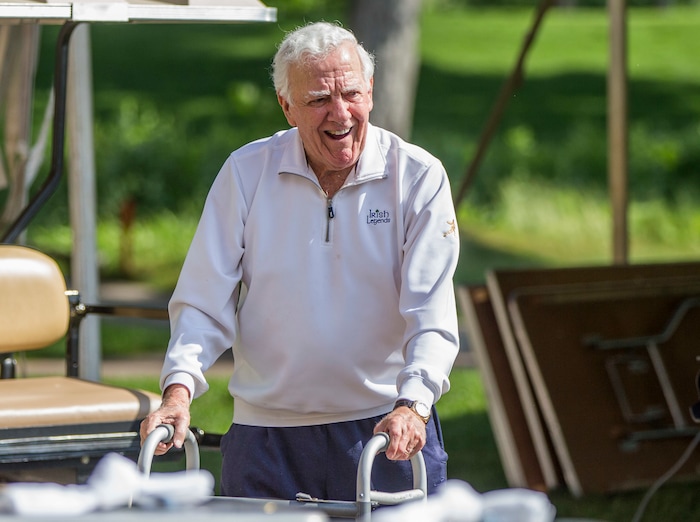 FILE - In this June 13, 2016, file photo, former Notre Dame football coach Ara Parseghian makes his way to an interview area during the Kelly Cares Foundation Golf Invitational at Lost Dunes Golf Club in Bridgman, Mich. Parseghian has returned to his home in Granger, Ind., after spending more than a week in a nursing care facility because of an infection in his surgically repaired hip. (Robert Franklin/South Bend Tribune via AP, File)