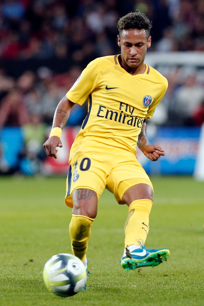 PSG's Neymar kicks the ball to make a pass during the French League One soccer match between Guingamp and PSG at the Roudourou stadium in Guingamp, western France, Sunday, Aug. 13, 2017. Neymar makes his long-awaited debut with Paris Saint-Germain on Sunday in the small Brittany town of Guingamp. (AP Photo/Kamil Zihnioglu)