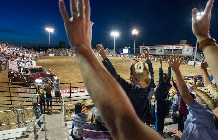 (Rick Egan  |  The Salt Lake Tribune)    Rodeo fans wave their hands hoping to get a free t-shirt, at the West Jordan Western Stampede Rodeo, Saturday, July 6, 2019.