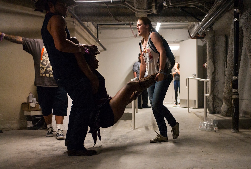 People assist a wounded woman at the Tropicana during an active shooter situation on the Las Vegas Stirp in Las Vegas Sunday, Oct. 1, 2017. Multiple victims were being transported to hospitals after a shooting late Sunday at a music festival on the Las Vegas Strip. (Chase Stevens/Las Vegas Review-Journal via AP)