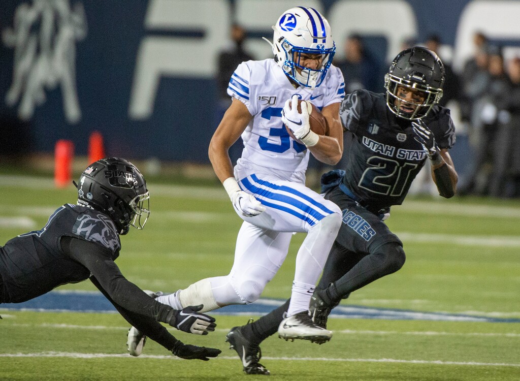(Rick Egan  |  The Salt Lake Tribune)       Brigham Young Cougars running back Sione Finau (35) runs the ball for the Cougars, in football action between Brigham Young Cougars and Utah State Aggies in Logan, Saturday, Nov. 2, 2019.