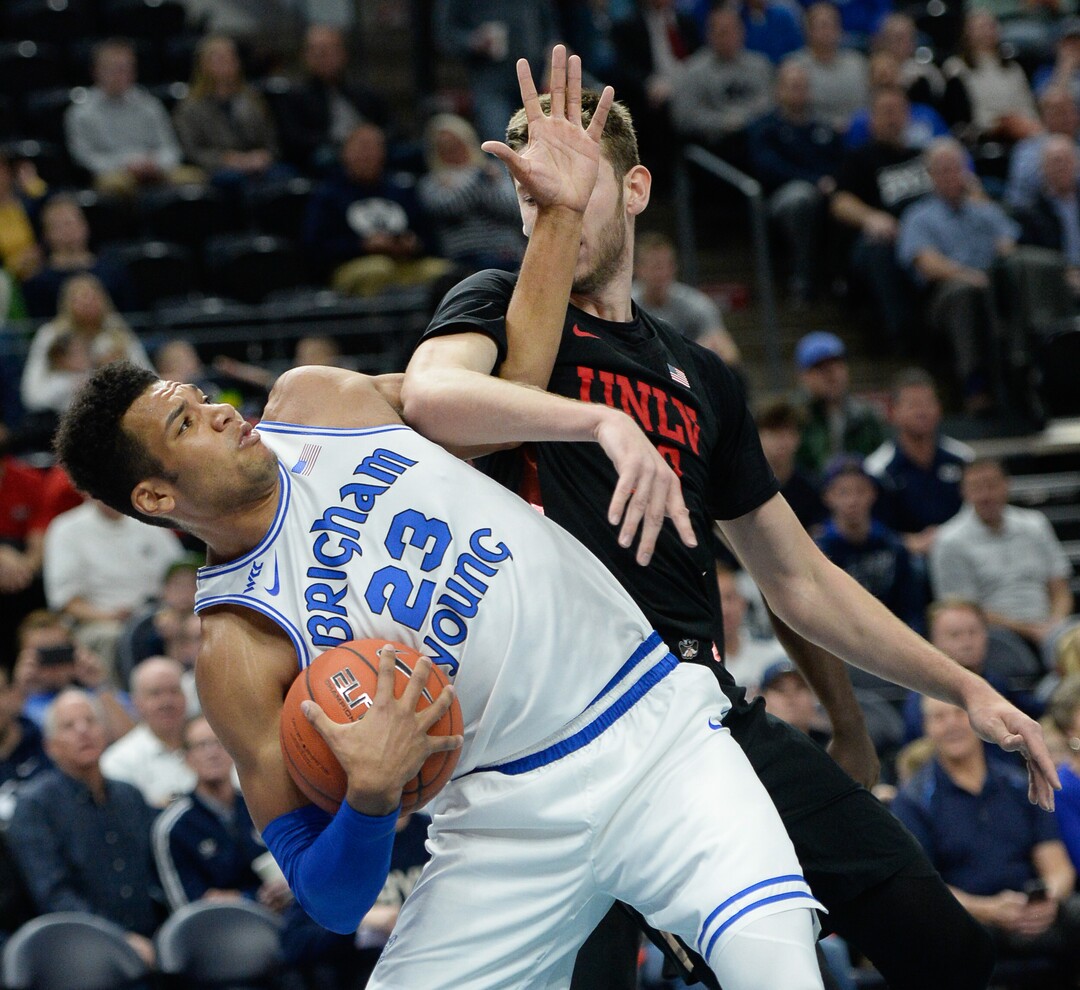 (Francisco Kjolseth  |  The Salt Lake Tribune)  Brigham Young Cougars forward Yoeli Childs (23) gets tangled with UNLV Rebels forward Vitaliy Shibel (22) as BYU takes on UNLV in men's NCAA basketball at Vivint Smart Home Arena in Salt Lake City on Sat. Dec. 7, 2019.