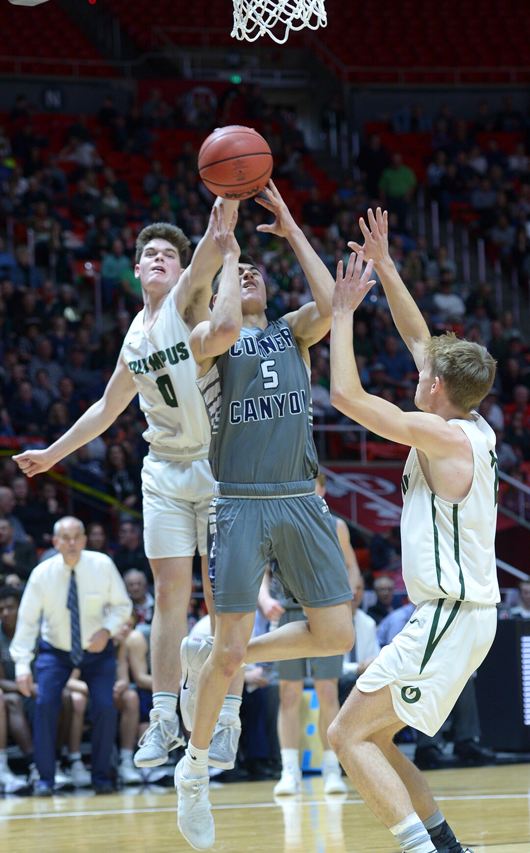 (Leah Hogsten  |  The Salt Lake Tribune) Olympus' Jeremy DowDell (00) swats at Corner Canyon's Luke Warnock (05).Olympus defeated Corner Canyon 76-49 to win the 5A High School BoysÕ Basketball Tournament Championship at the Jon M. Huntsman Center in Salt Lake City,  Friday, March 2, 2018. 