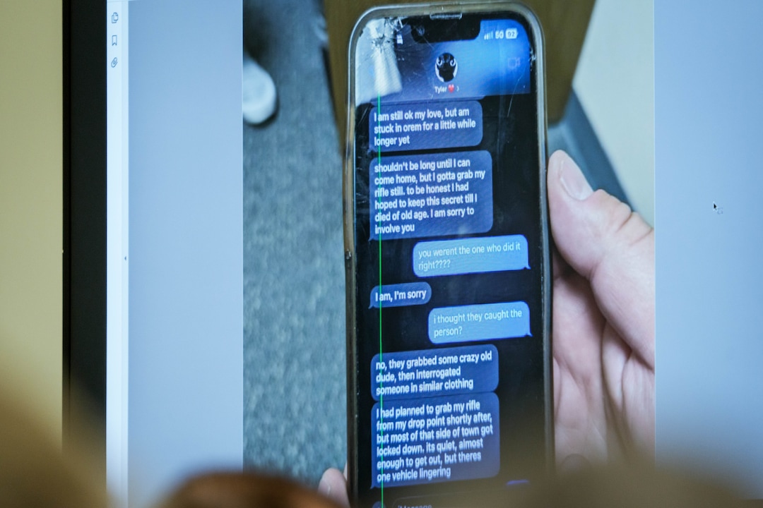 (Spenser Heaps | Pool) A photograph which prosecutors say shows a text message exchange between Tyler Robinson, who is accused in the fatal shooting of Charlie Kirk, and Robinson’s roommate and romantic partner Lance Twiggs, is shown during a preliminary hearing at the Fourth District Courthouse in Provo, Thursday, July 9, 2026.