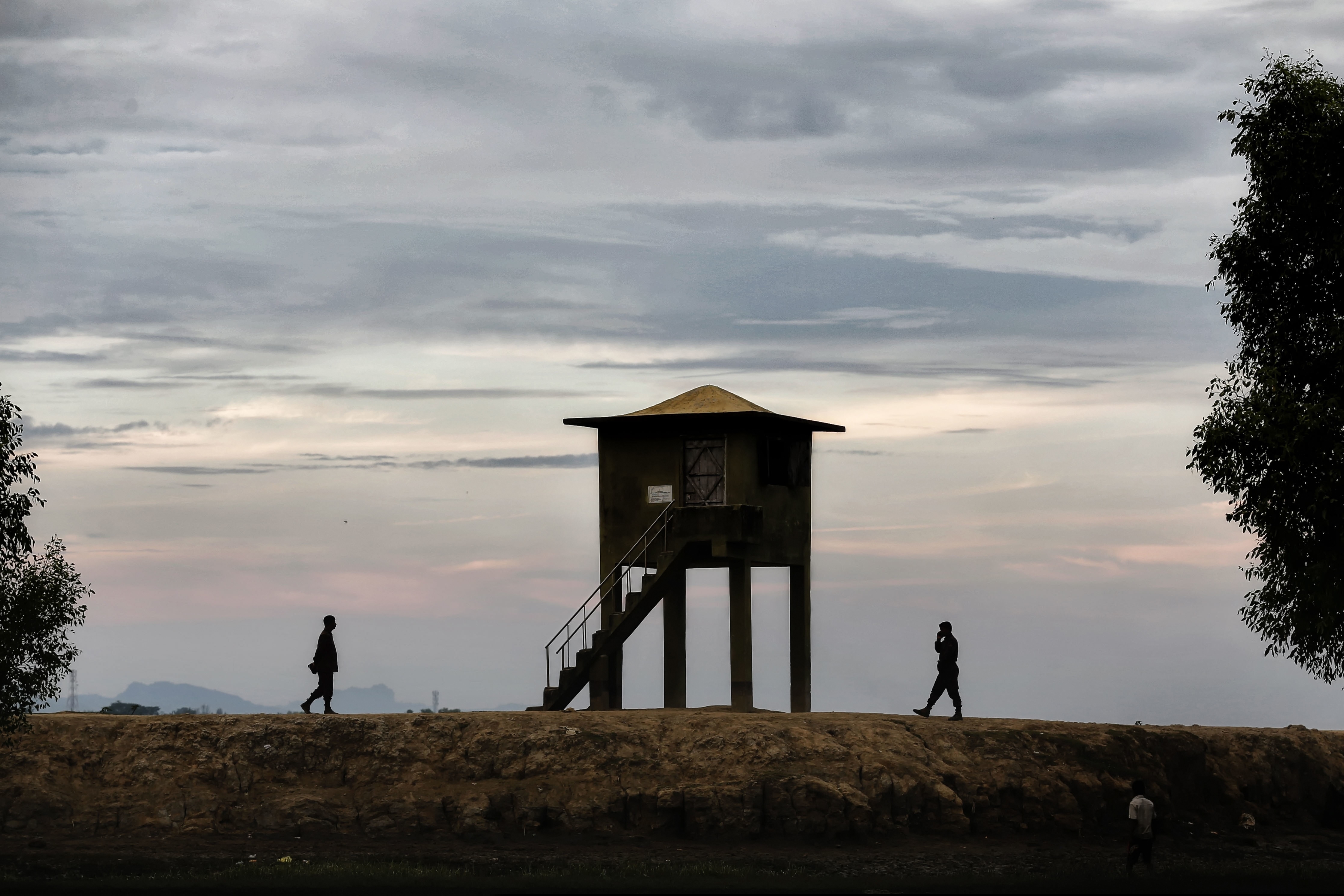 FILE- In this Dec.2, 2016 file photo, members of the Border Guard Bangladesh (BGB) guard at a common transit point for Rohingya along the banks of the Naf River, which marks the border between Bangladesh and Myanmar in Teknaf, near Cox's Bazar, Bangladesh. Bangladeshi security officials on Monday fatally shot seven suspected members of a Rohingya refugee gang allegedly involved in drug dealing and human trafficking, officials said. (AP Photo/A.M. Ahad, File)