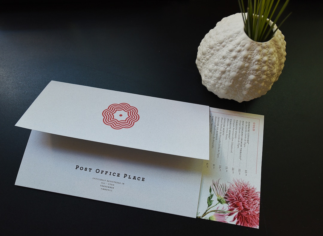 (Francisco Kjolseth  |  The Salt Lake Tribune)  Post Office Place, a new bar by the same owners as Takashi, located next door, welcomes patrons on Tuesday, June 19, 2018 with a menu that can be used as a post card. One of the main reasons Takashi and Tamara Gibo opened this downtown watering hole is so that their patrons could have a drink while waiting for a seat at Takashi where the wait can sometimes be an hour long and liquor laws don't allow cocktails unless you are seated.
