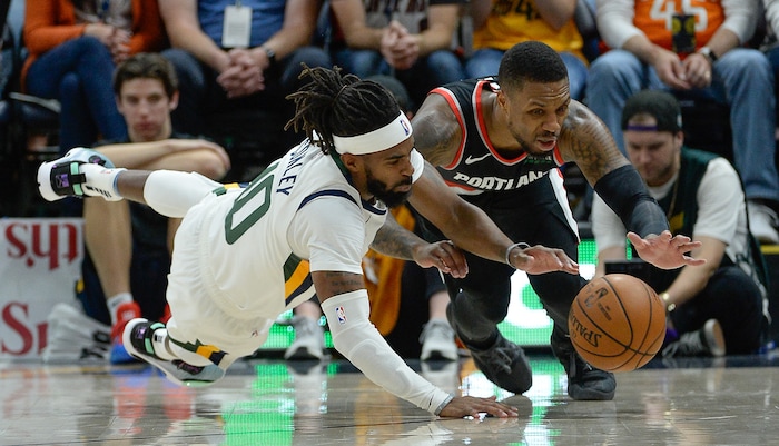 (Francisco Kjolseth  |  The Salt Lake Tribune)  Utah Jazz guard Mike Conley (10) battles Portland Trail Blazers guard Damian Lillard (0) for a loose ball as the Utah Jazz host the Portland Trailblazers in their NBA basketball game at Vivint Smart Home Arena in Salt Lake City on Wed. Oct. 16, 2019.