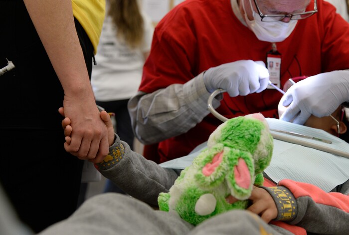 (Francisco Kjolseth  |  The Salt Lake Tribune) A young patient is comforted by first year dental student Lauren Kvam at the University of Utah as part of the American Dental AssociationÕs ÒGive Kids a SmileÓ program on Saturday, Feb. 29, 2020. The effort launched in 2003 gives no-cost care to thousands of kids nationwide.