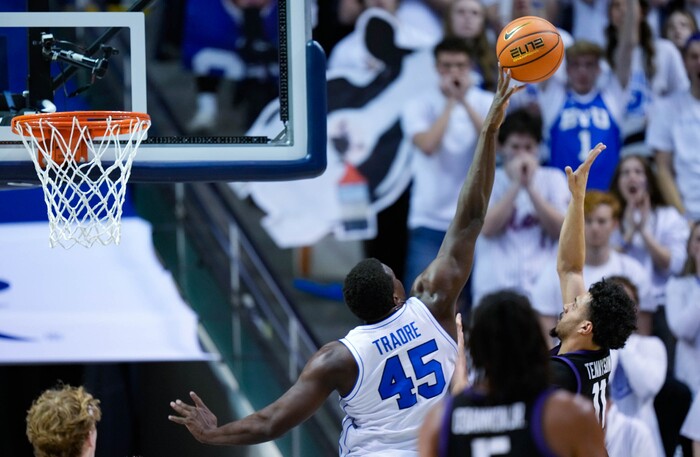 (Francisco Kjolseth | The Salt Lake Tribune) Brigham Young Cougars forward Fousseyni Traore (45) puts the block on TCU Horned Frogs guard Trevian Tennyson (11) during an NCAA college basketball game against TCU Saturday, March 2, 2024, in Provo, Utah.