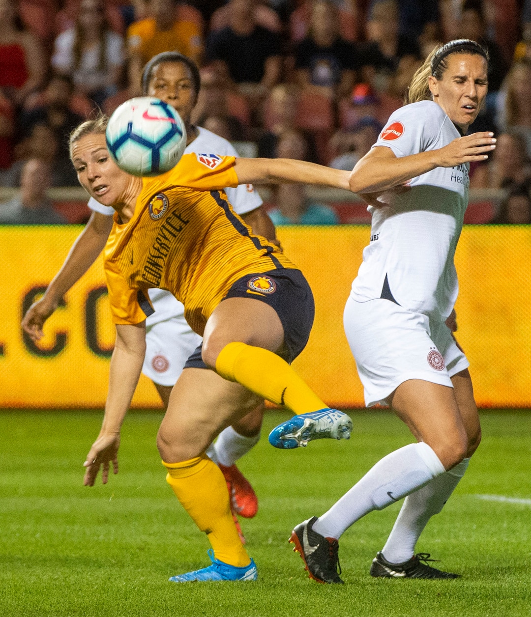 (Rick Egan  |  The Salt Lake Tribune)    Utah Royals FC forward Amy Rodriguez (8) goes for the ball as Portland Thorns FC defender Katherine Reynolds (2) defends, in Soccer action between Utah Royals FC and Portland Thorns FC, in Sandy, Friday, July 19, 2019.