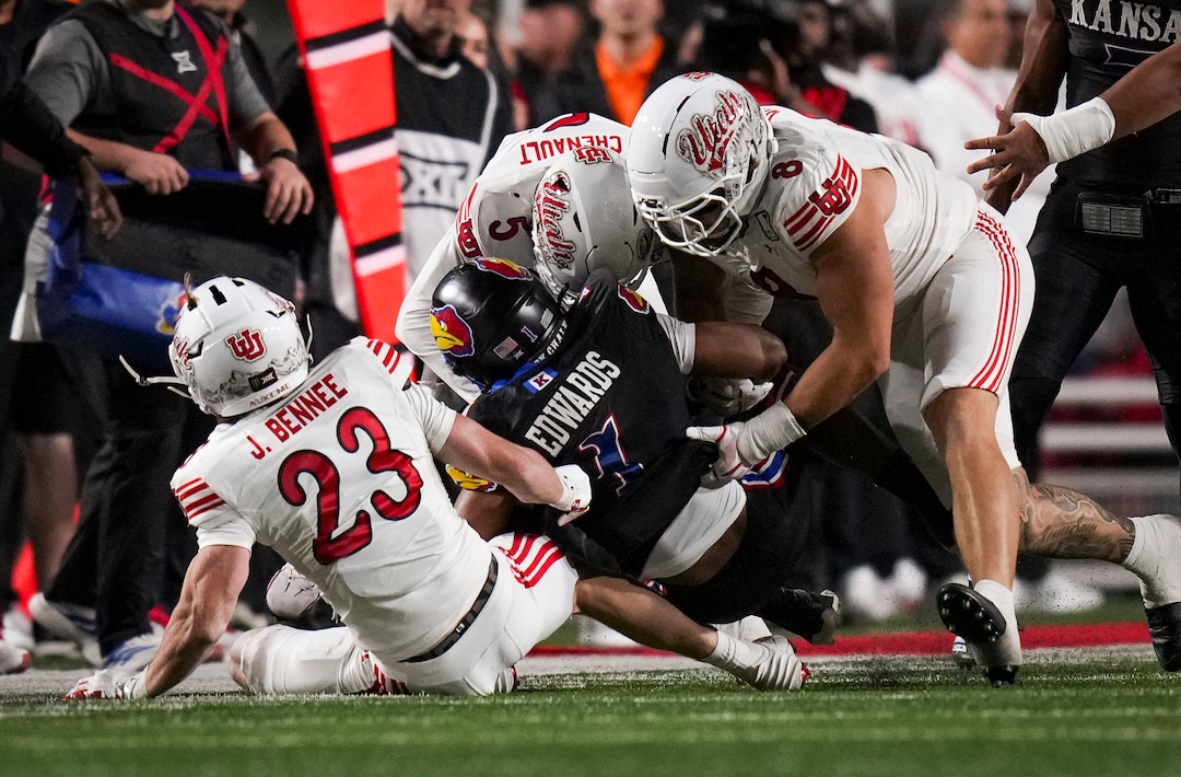 (Bethany Baker  |  The Salt Lake Tribune) Utah Utes safety Jackson Bennee (23), cornerback James Chenault Jr. (5) and defensive end Ethan Day (8) tackle Kansas Jayhawks running back Dylan Edwards (1) during the game between the Utah Utes and the Kansas Jayhawks at Rice-Eccles Stadium in Salt Lake City on Saturday, Oct. 10, 2026.