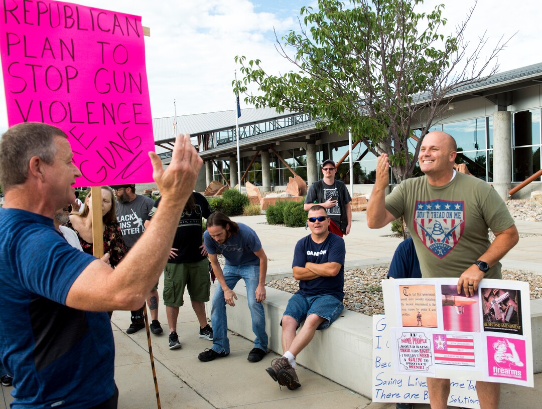 (Rick Egan  |  The Salt Lake Tribune)   Eric Wilson from Salt Lake CIty, (left) argues with Eric Kish North from South Jordan, points out that he is carrying a weapon, as he argues against gun control, before a town hall meeting in Sandy, where survivors from the Florida school shooting held a forum with Utah students involved with the March for Our Lives movement, Saturday, July 14, 2018.