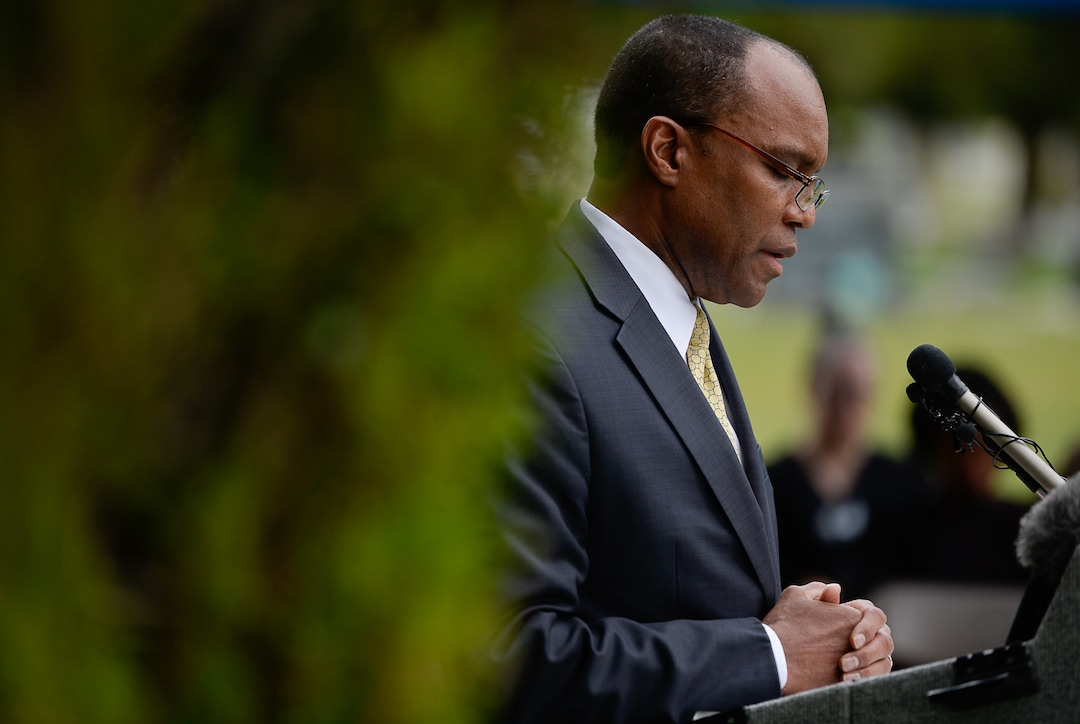 (Francisco Kjolseth  |  The Salt Lake Tribune)  Pastor Marlin Lynch III, performs the closing prayer during the dedication of the first grave marker for Tom, an enslaved Black pioneer who was buried in the Salt Lake City Cemetery in 1862. Smoot, a well-known pioneer and the second mayor of Salt Lake City, eventually acquired Tom, according to 1850 County census records. Tom was baptized in the Sugarhouse Ward by Henry A. Cheever on June 24th, 1854. Tom died from causes listed as Òinflammation of the chestÓ in 1862 at the age of 42 and was buried in the pauper's section of the Salt Lake City Cemetery.