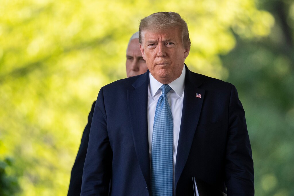 President Donald Trump, followed by Vice President Mike Pence, walks on the Colonnade to speak about the coronavirus in the Rose Garden of the White House, Wednesday, April 15, 2020, in Washington. (AP Photo/Alex Brandon)