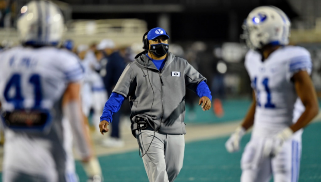 BYU head coach Kalani Sitake, center, walks on the field during the first half of an NCAA college football game against Coastal Carolina Saturday, Dec. 5, 2020, in Conway, S.C. (AP Photo/Richard Shiro)