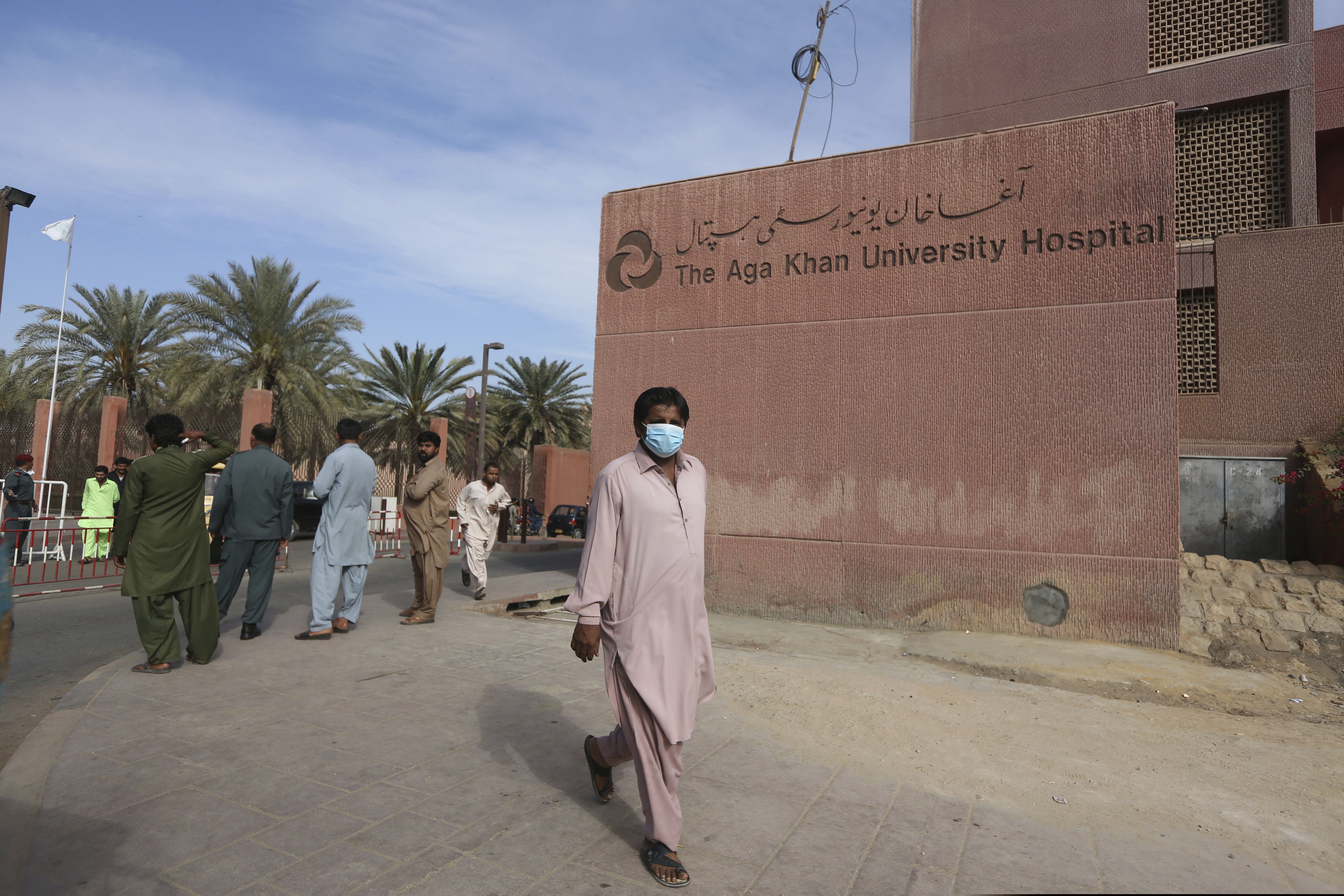 (Fareed Khan | AP) A Pakistani man wearing a face mask walks past the Aga Khan hospital where a patient suspected of having contracted coronavirus was admitted, in Karachi, Pakistan, Thursday, Feb. 27, 2020.