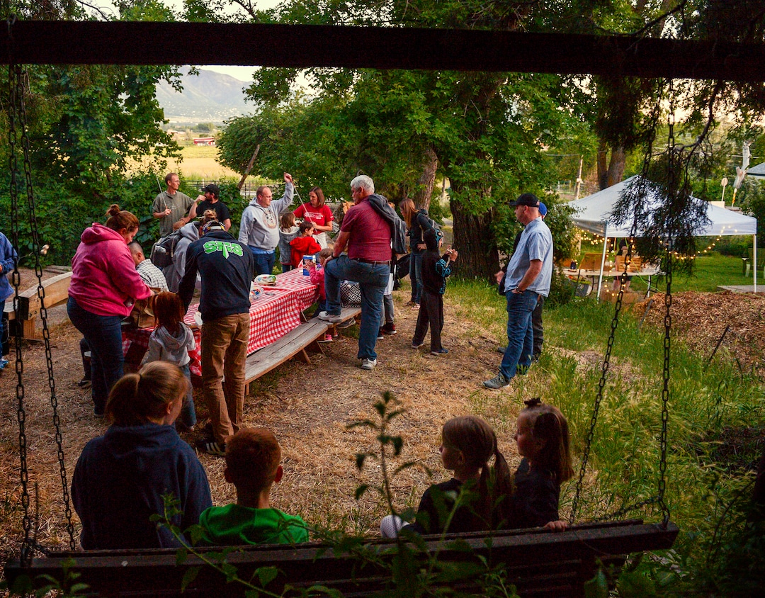 (Leah Hogsten  |  The Salt Lake Tribune) Visitors to Thompson Century Farm gather around the campfire prior to a tour of the hay fields to see fireflies, to eat s'mores and hear about the farm’s history and facts about fireflies and their fragile ecosystem from Diane Garcia. Fireflies have been twinkling in the hay fields of Garcia's family farm, Thompson Century Farm near Spanish Fork, since her great-great-grandfather Samuel Thompson settled the farm in 1800s. The farm and its wet, marshy habitat is perfect for the fireflies' annual mating rituals every year, roughly from late May to early July. Garcia leads tours through her fields for free, simply to share in the experience and to educate others about fireflies, their short-lived lifecycle and what endangers their fragile habitat.