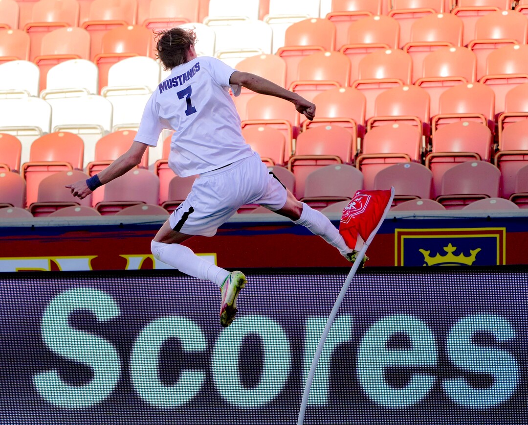 (Francisco Kjolseth | The Salt Lake Tribune) Herriman's Trevor Walk (7) leaps with excitement as he kicks the corner flag after scoring the game winning goal over Davis with only two seconds left on the clock during the 6A State Soccer Championship title game at Rio Tinto Stadium, Wednesday, May 25, 2022. Herriman defeated Davis 1-0.