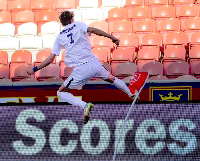 (Francisco Kjolseth | The Salt Lake Tribune) Herriman's Trevor Walk (7) leaps with excitement as he kicks the corner flag after scoring the game winning goal over Davis with only two seconds left on the clock during the 6A State Soccer Championship title game at Rio Tinto Stadium, Wednesday, May 25, 2022. Herriman defeated Davis 1-0.
