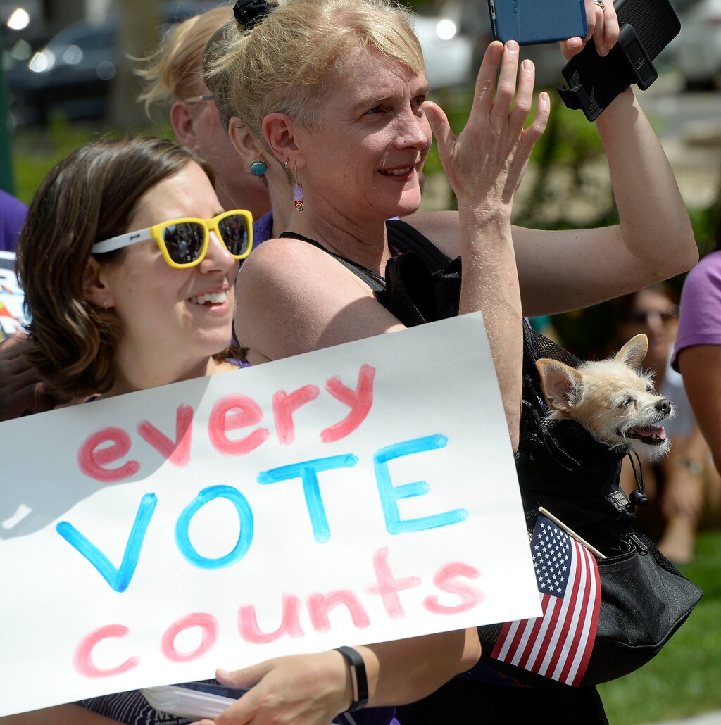 (Al Hartmann  |  The Salt Lake Tribune) "Tikva Pearl, a big supporter of the cause joins rally with owner Judi Hilman with Salt Lake Indivisible,Mormon Women for Ethical Government, and Action Utah members in a rally against the confusing process of special election to fill Chaffetz' 3rd District seat outside the historical courthouse in Provo Monday Aug 14. 