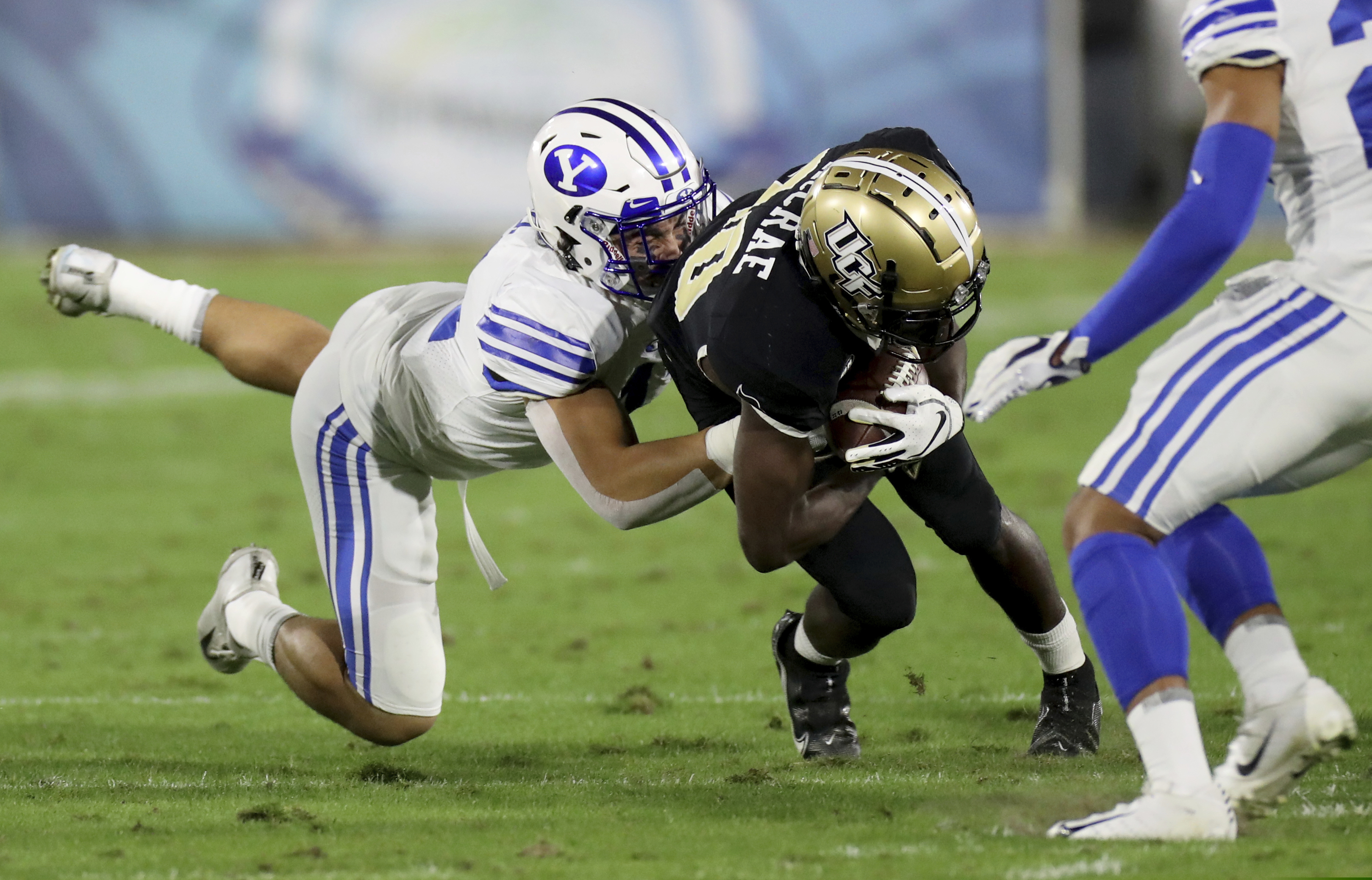 Central Florida's Greg McCrae is tackled after making a reception in the first quarter against BYU in the Boca Raton Bowl NCAA college football game Tuesday, Dec. 22, 2020, in Boca Raton, Fla. (Mike Stocker/South Florida Sun-Sentinel via AP)