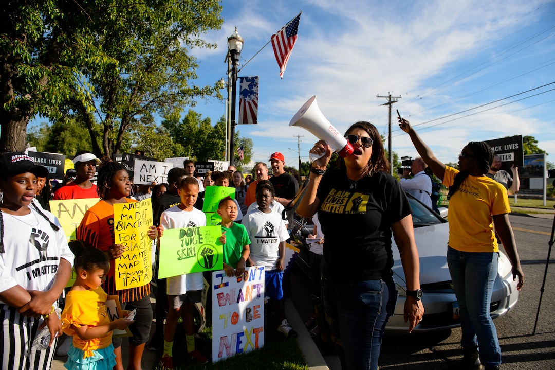 (Trent Nelson  |  The Salt Lake Tribune)Lex Scott leads chants at a protest organized by Black Lives Matter and other groups at the Woods Cross Police Department on Friday June 14, 2019. The rally was to show support for DJ Hrubes, a 10-year-old black child who was held at gunpoint by a police officer last week while playing in his grandmother's front yard.