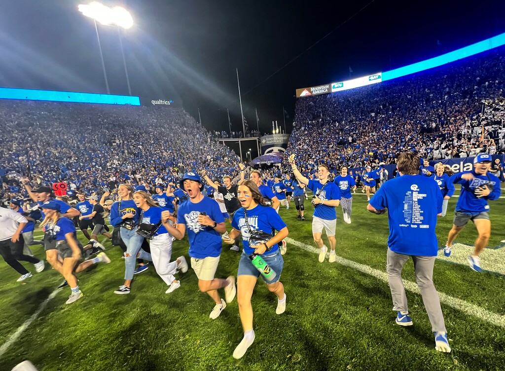 (Rick Egan | The Salt Lake Tribune) Brigham Young Cougars fans flood the field as they celebrate the BYU win over the Baylor Bears in double-overtime, at Lavell Edwards Stadium in Provo, on Saturday, Sept. 10, 2022.