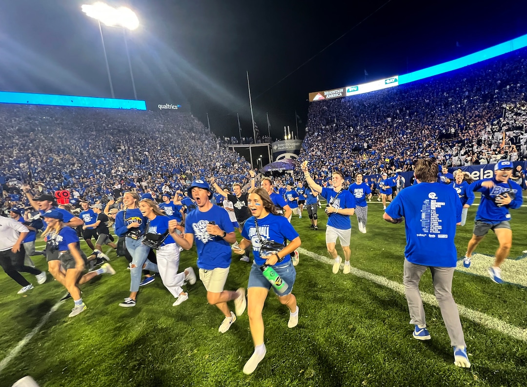 (Rick Egan | The Salt Lake Tribune) Brigham Young Cougars fans flood the field as they celebrate the BYU win over the Baylor Bears in double-overtime, at Lavell Edwards Stadium in Provo, on Saturday, Sept. 10, 2022.