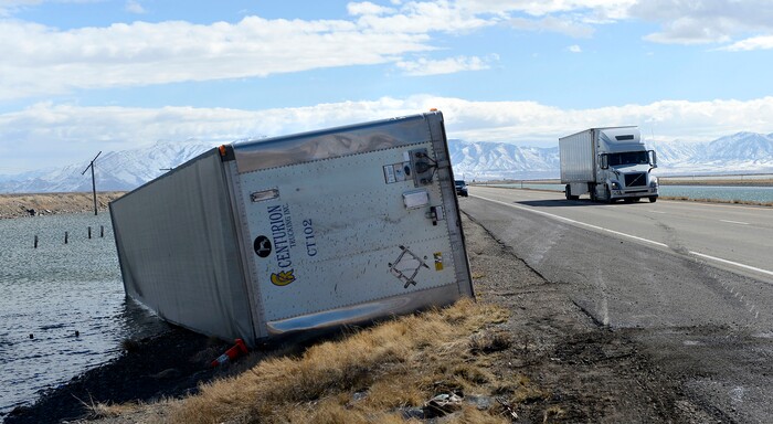 (Al Hartmann  |  The Salt Lake Tribune) 	One of three semi truck trailers that flipped over on I-80 westbound in high winds around 8:00 a.m. Friday March 2.  The incidents happened between mile posts 79 to 82 just east of the Rowley-Dugway exit in Tooele County.   Wrecking crews were kept busy all morning righting the rigs. 