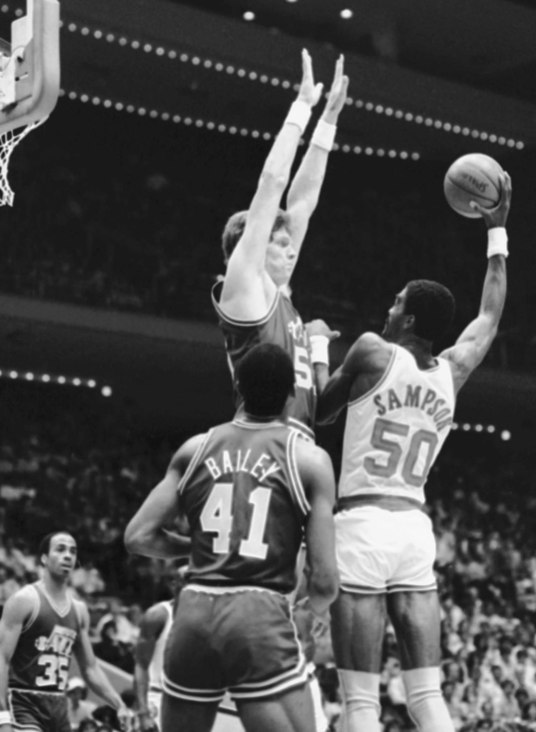 Houston Rockets Ralph Sampson (50), at 74, takes aim over Utah Jazz Mark Eaton, also 74, during the first quarter of the NBA playoff game at the Summit, Sunday, April 22, 1985, Houston, Tex. Rockets won game two, to even the best of five series at one victory for each team. (AP Photo/F. Carter Smith)