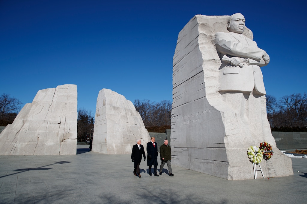 President Donald Trump, center, Vice President Mike Pence, left, escorted by Acting Interior Secretary David Bernhardt, right, visit the Martin Luther King Jr. Memorial, Monday, Jan. 21, 2019, in Washington.  (AP Photo/ Evan Vucci)